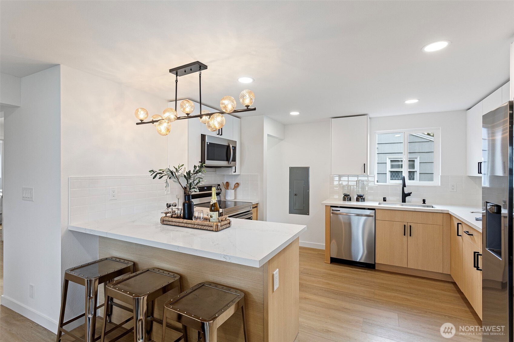 8608 16th Avenue Southwest Seattle, WA 98106 - Photo 7 of 26 a kitchen with stainless steel appliances a sink stove and wooden floor