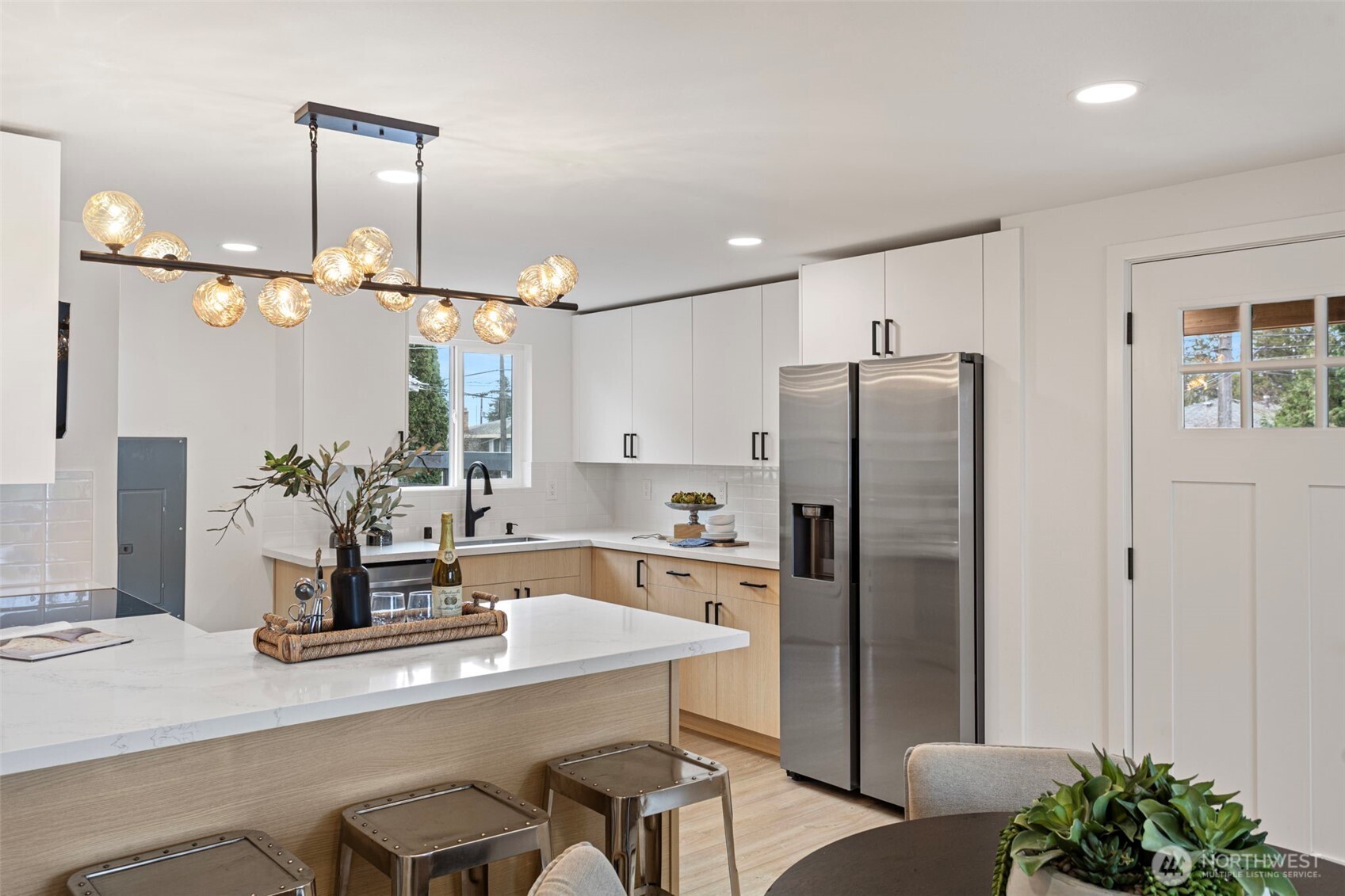 8608 16th Avenue Southwest Seattle, WA 98106 - Photo 8 of 26 a kitchen with kitchen island a refrigerator and a sink