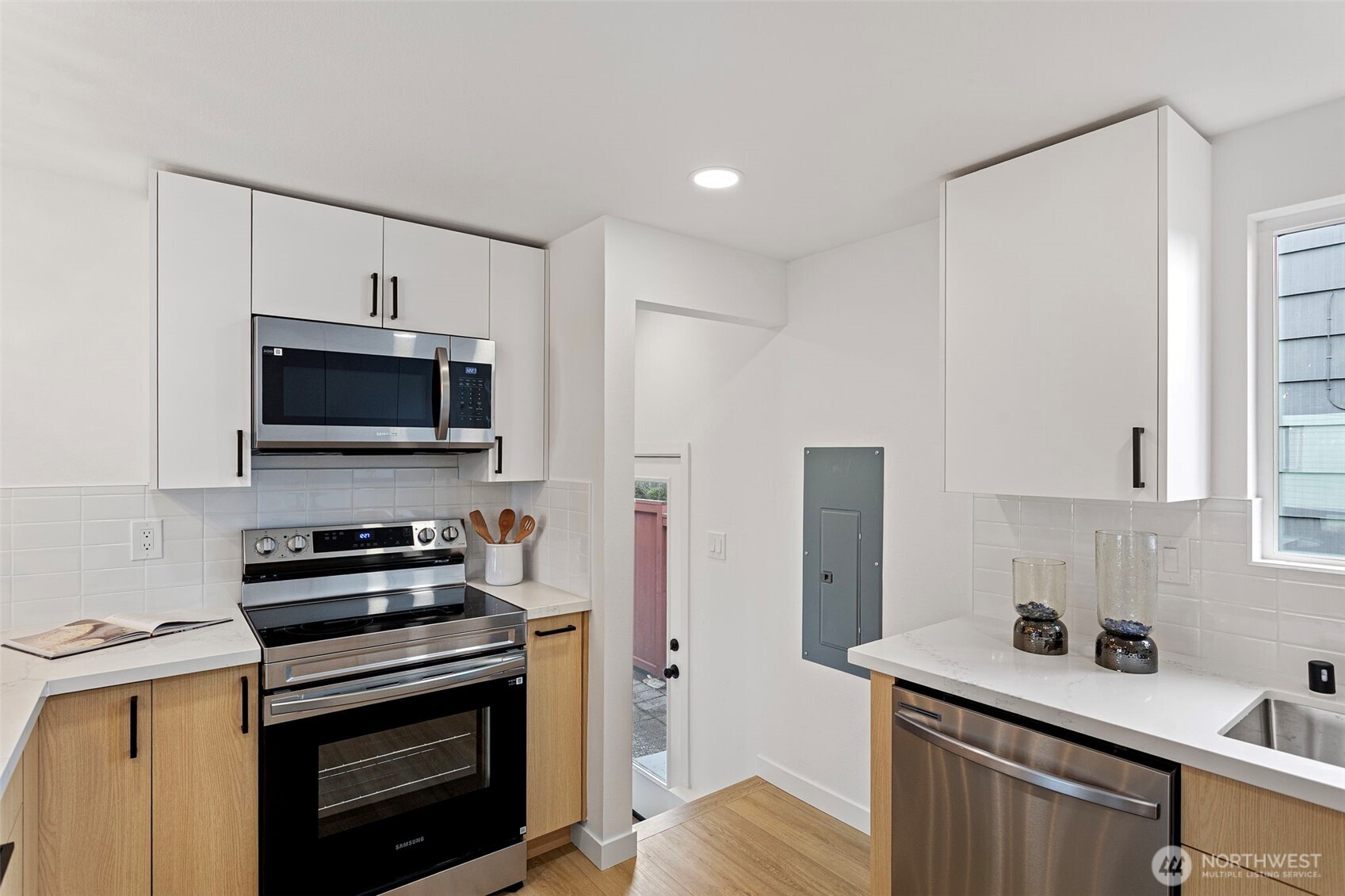 8608 16th Avenue Southwest Seattle, WA 98106 - Photo 9 of 26 a kitchen with a stove and a microwave