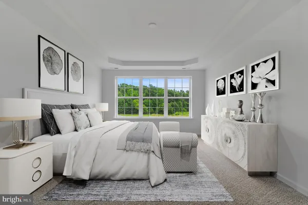 a large white bed sitting in a bedroom next to a window