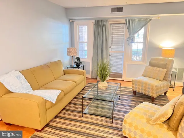 a living room with furniture and a rug