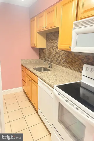 a kitchen with a sink cabinets and utility