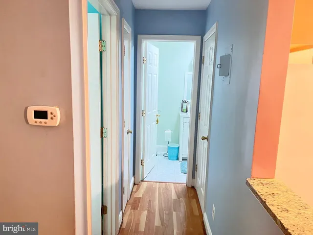 a view of a hallway with wooden floor and staircase