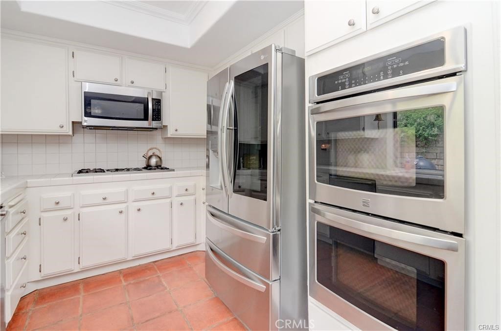25095 Perch Drive Dana Point, CA 92629 - Photo 13 of 30 a kitchen with stainless steel appliances white cabinets and a stove top oven