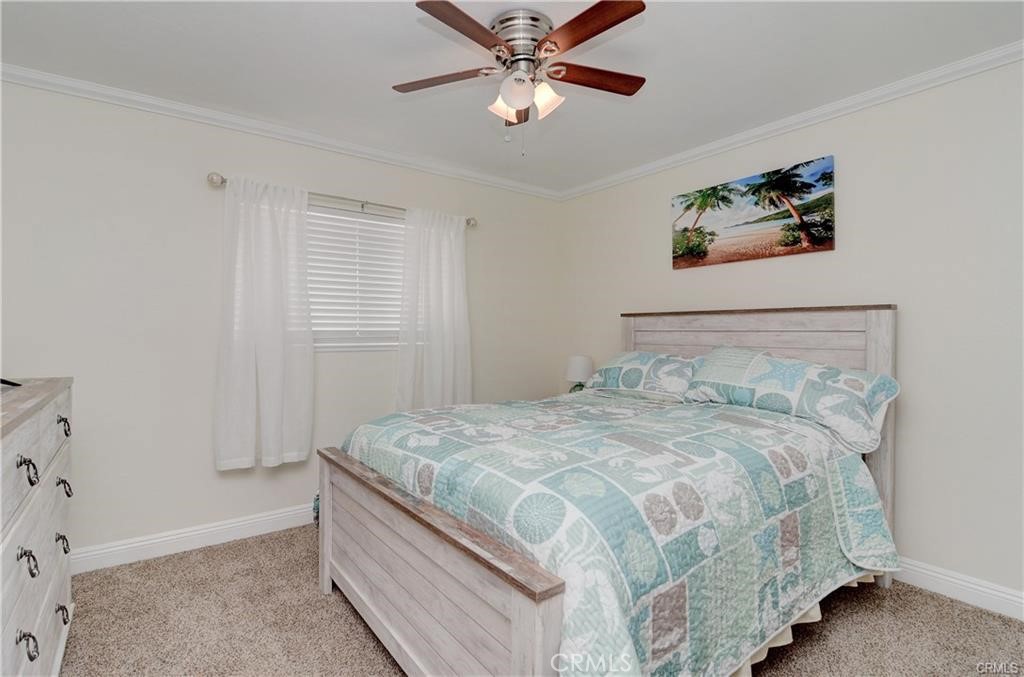 25095 Perch Drive Dana Point, CA 92629 - Photo 20 of 30 a bedroom with a bed and a chandelier