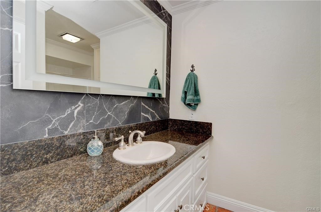 25095 Perch Drive Dana Point, CA 92629 - Photo 22 of 30 a bathroom with a granite countertop sink and a mirror