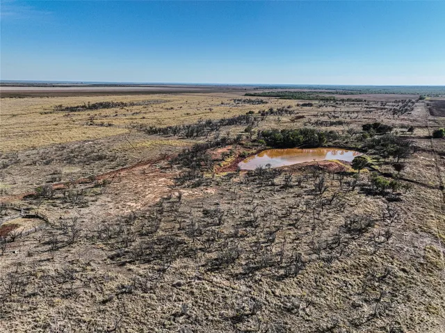 an aerial view of house with ocean view