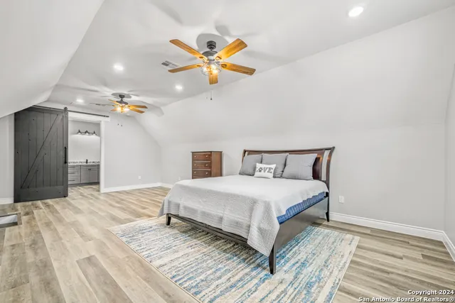 a bedroom with a bed and ceiling fan