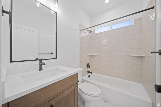 1117 East Shilow Road, Unit 106 Erda, UT 84074 - Photo 16 of 21 Bathroom featuring a wood-finish vanity with a white countertop and integrated sink, matte black faucet, and framed mirror