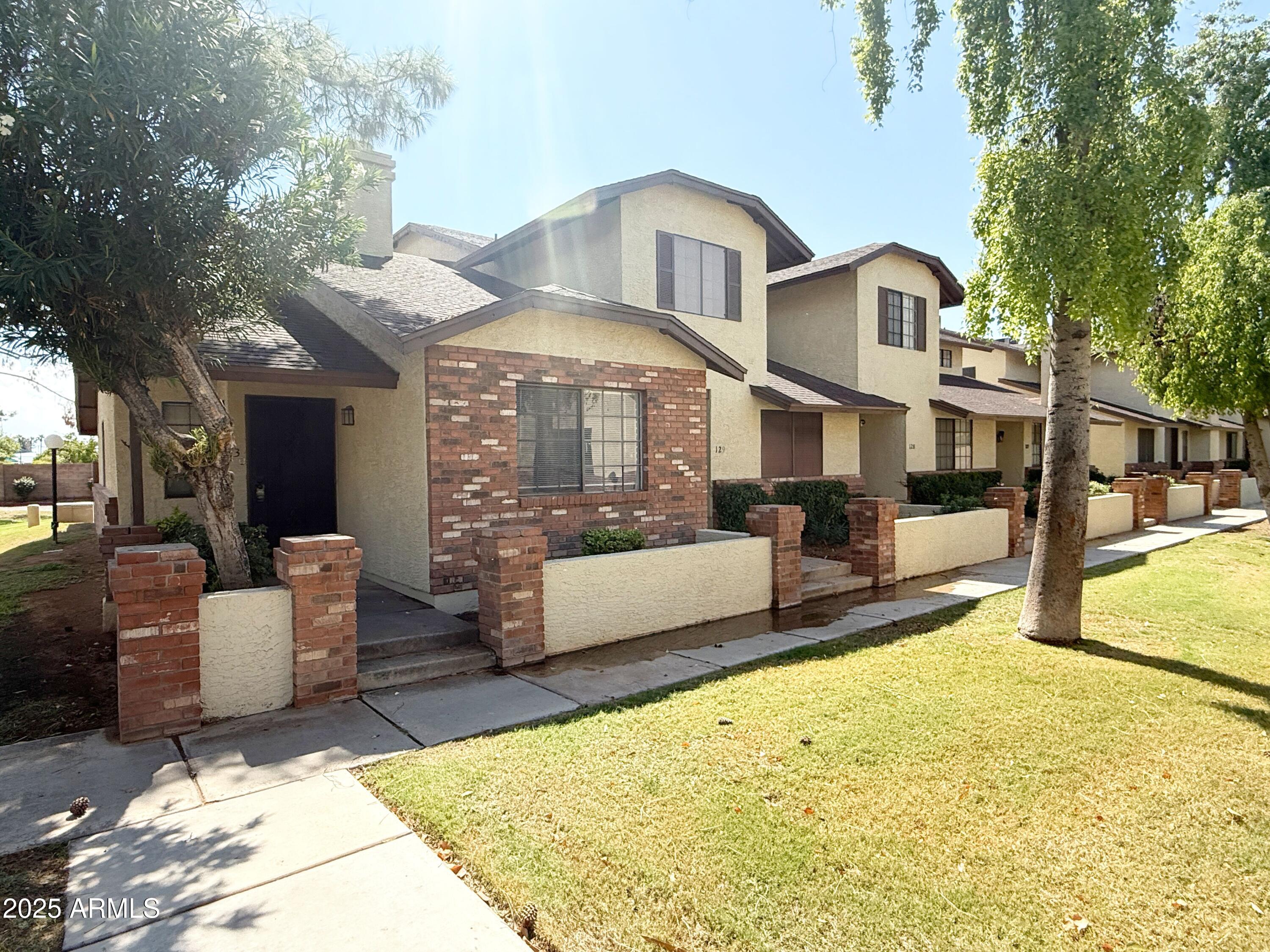 170 East Guadalupe Road, Unit 130 Gilbert, AZ 85234 - Photo 1 of 18 a view of a house with swimming pool and sitting area
