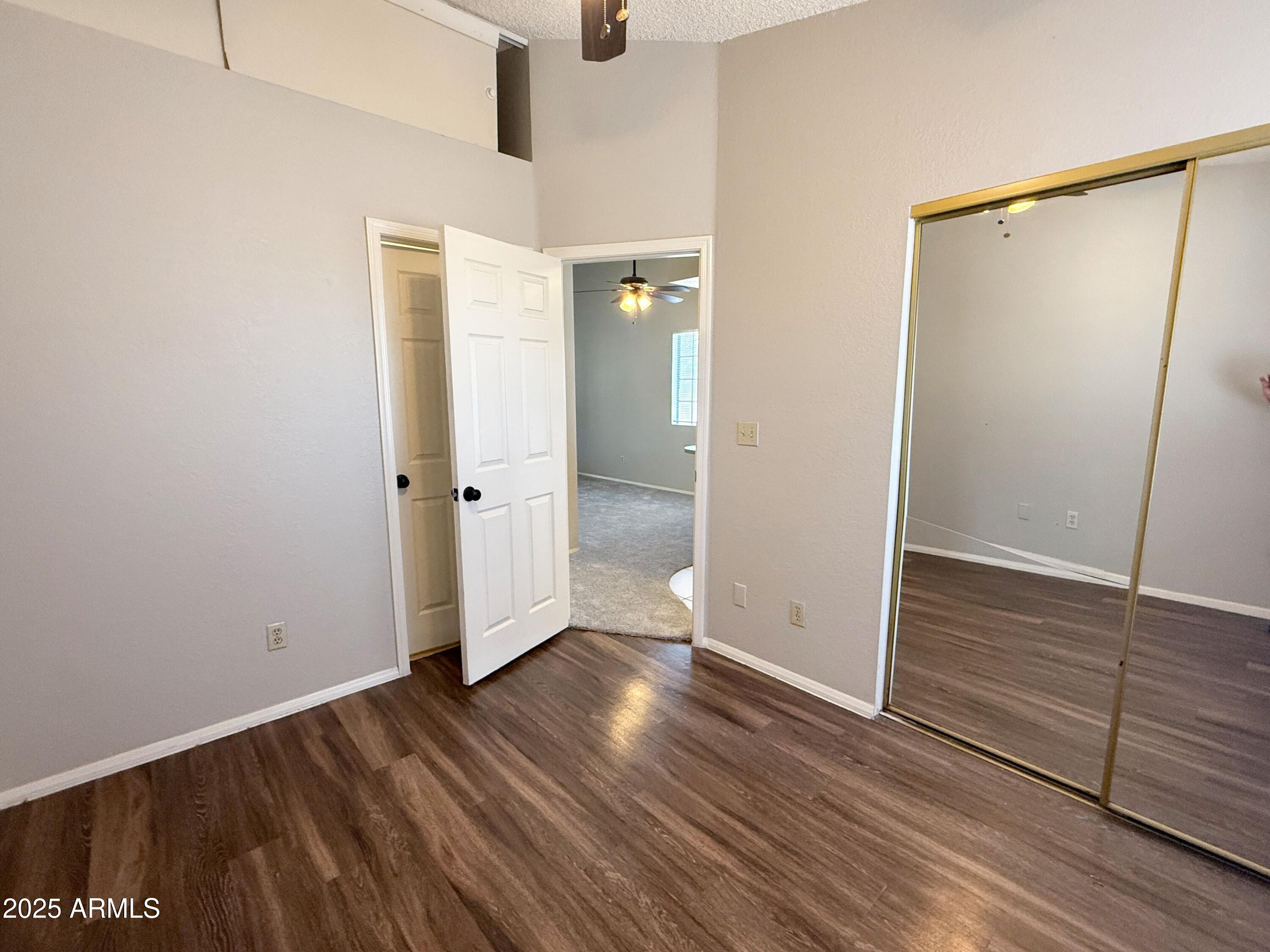 170 East Guadalupe Road, Unit 130 Gilbert, AZ 85234 - Photo 12 of 18 an empty room with wooden floor