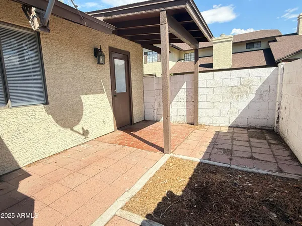 a view of a balcony with wooden floor and iron fence