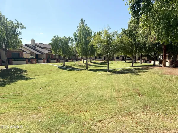 a view of an house with swimming pool and yard