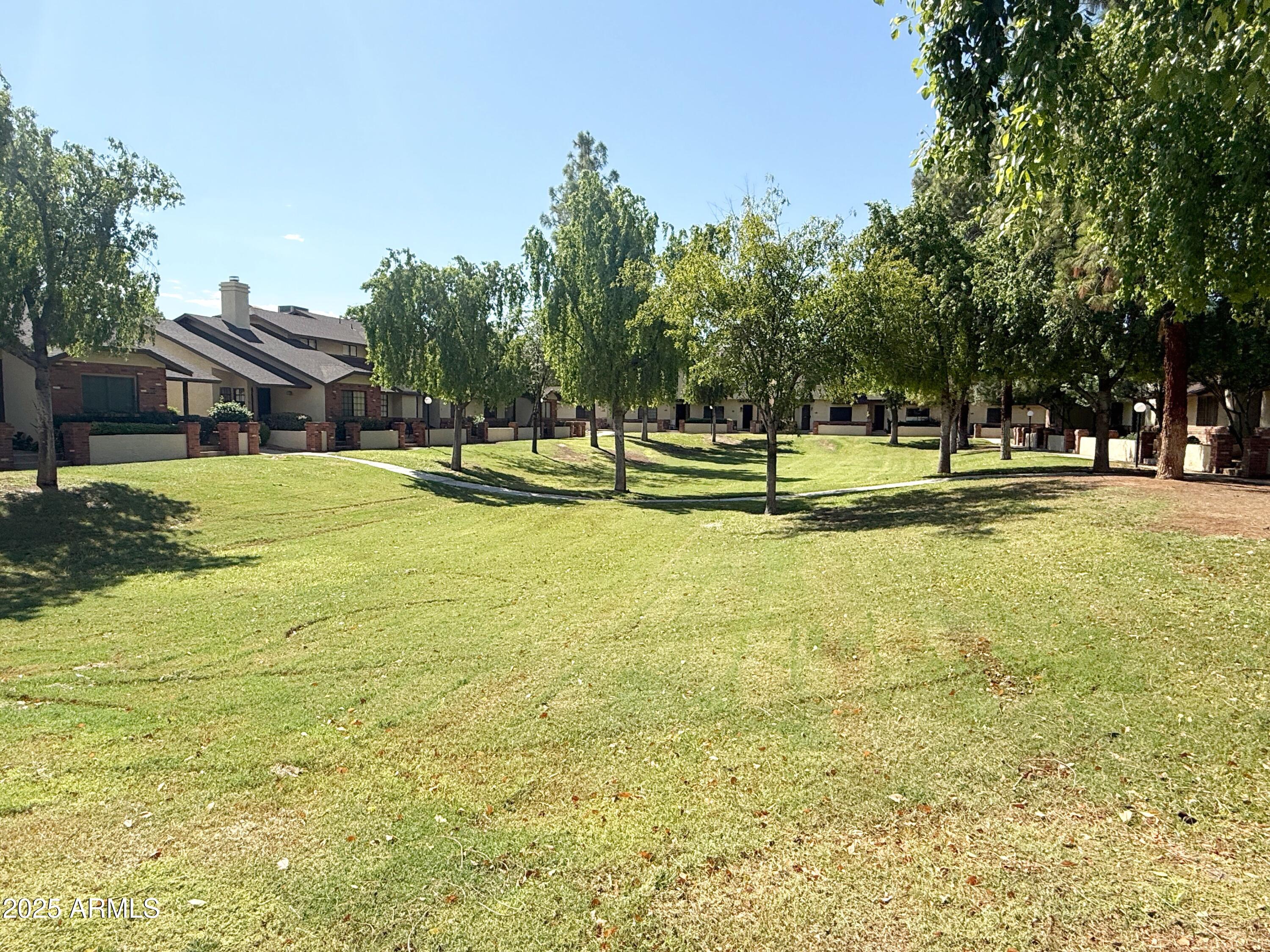 170 East Guadalupe Road, Unit 130 Gilbert, AZ 85234 - Photo 17 of 18 a view of an house with swimming pool and yard