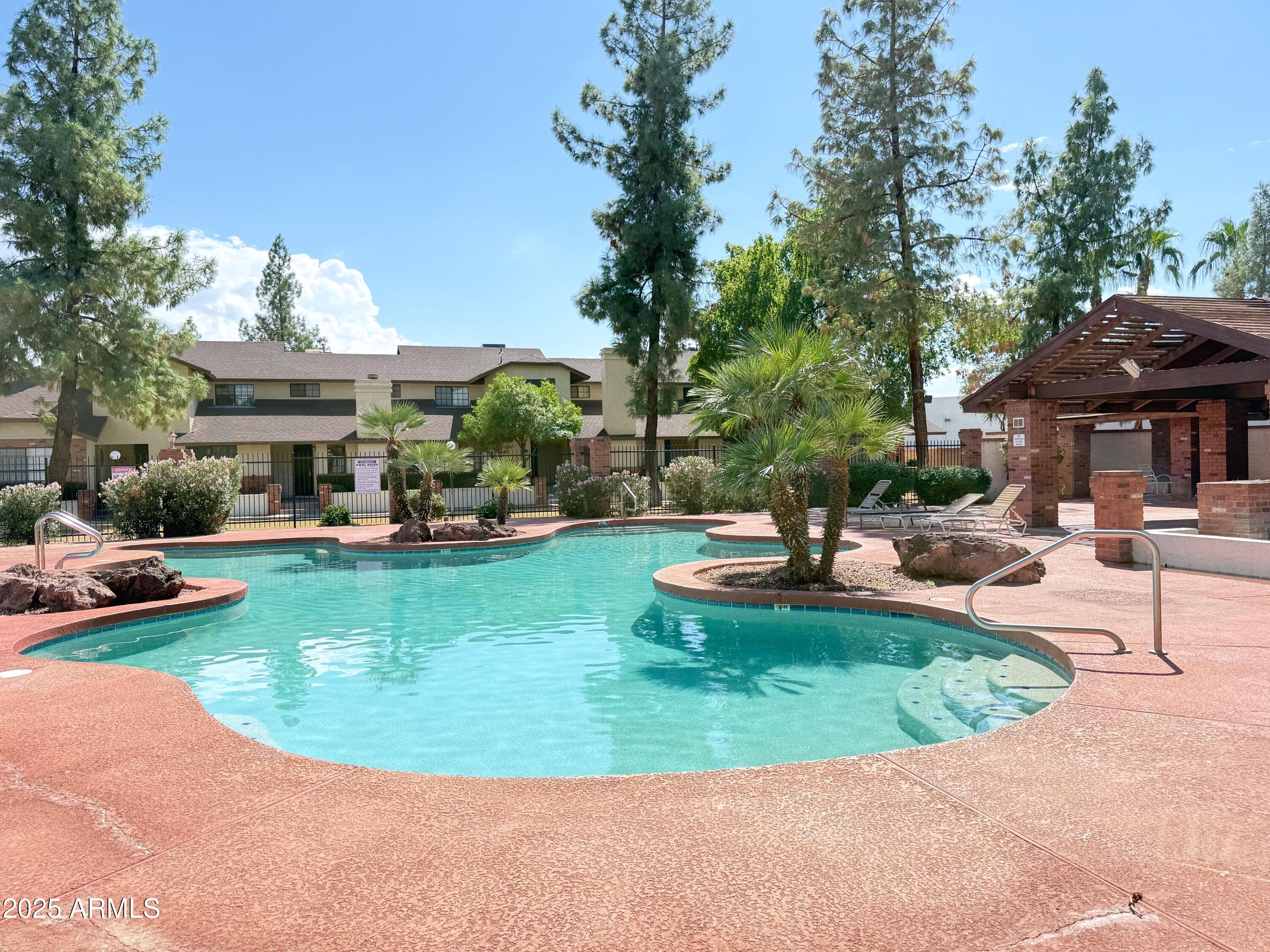 170 East Guadalupe Road, Unit 130 Gilbert, AZ 85234 - Photo 18 of 18 a view of a house with swimming pool and sitting area