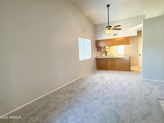 a big room with chandelier and windows