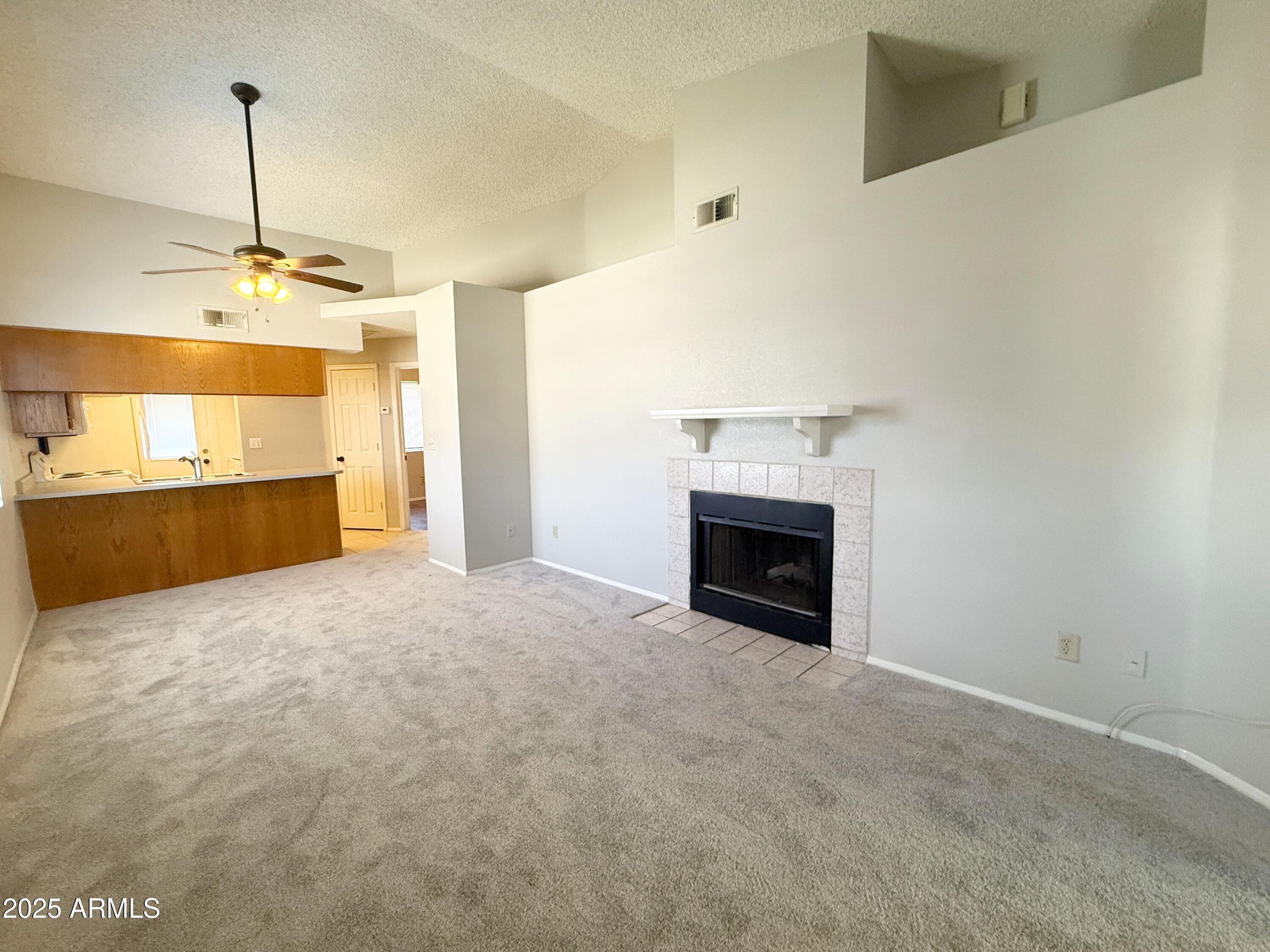 170 East Guadalupe Road, Unit 130 Gilbert, AZ 85234 - Photo 3 of 18 a view of a kitchen with a sink and a fireplace