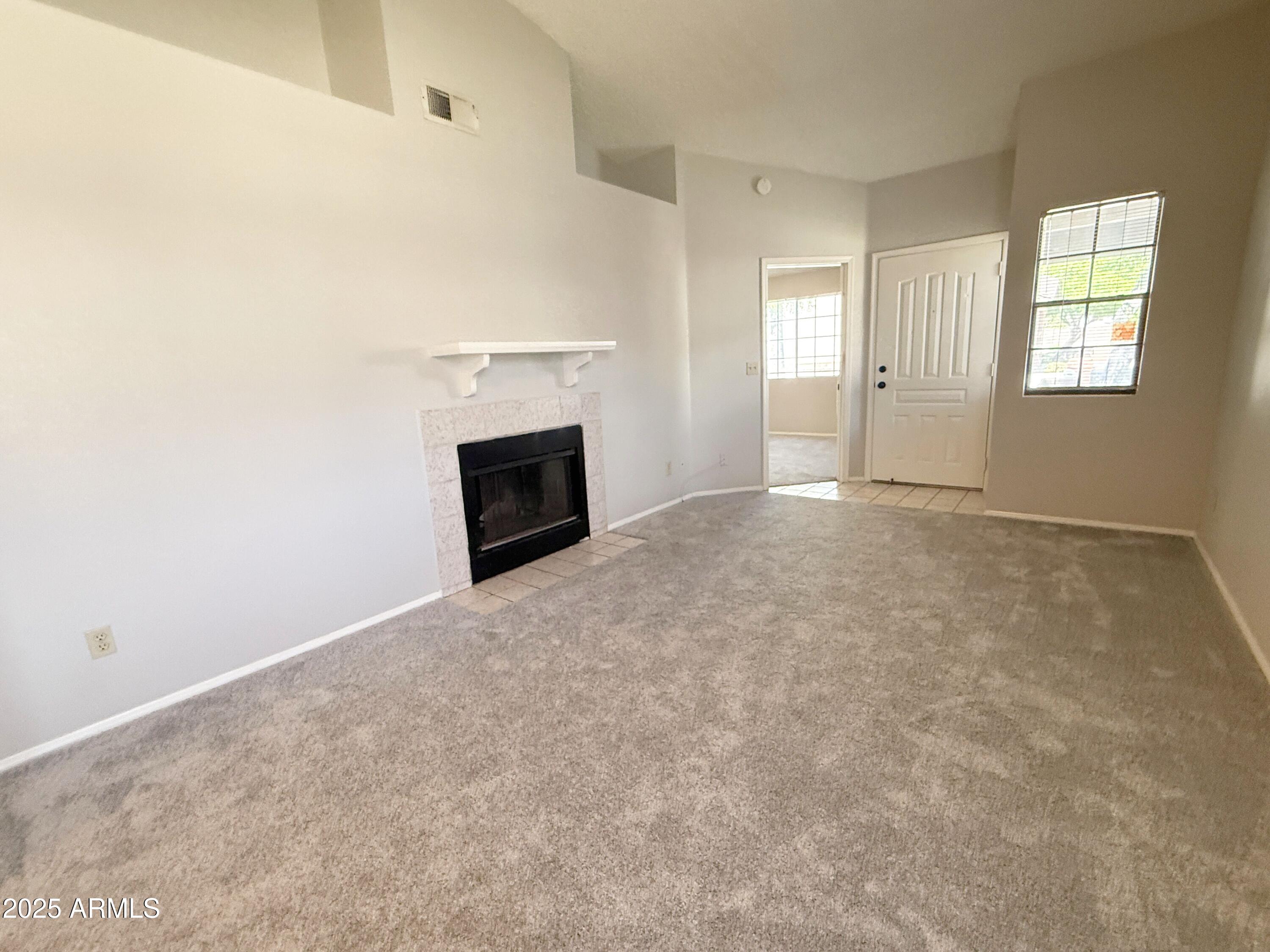 170 East Guadalupe Road, Unit 130 Gilbert, AZ 85234 - Photo 4 of 18 an empty room with windows