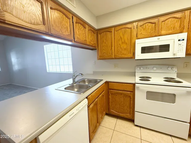 a kitchen with stainless steel appliances granite countertop a sink and a stove