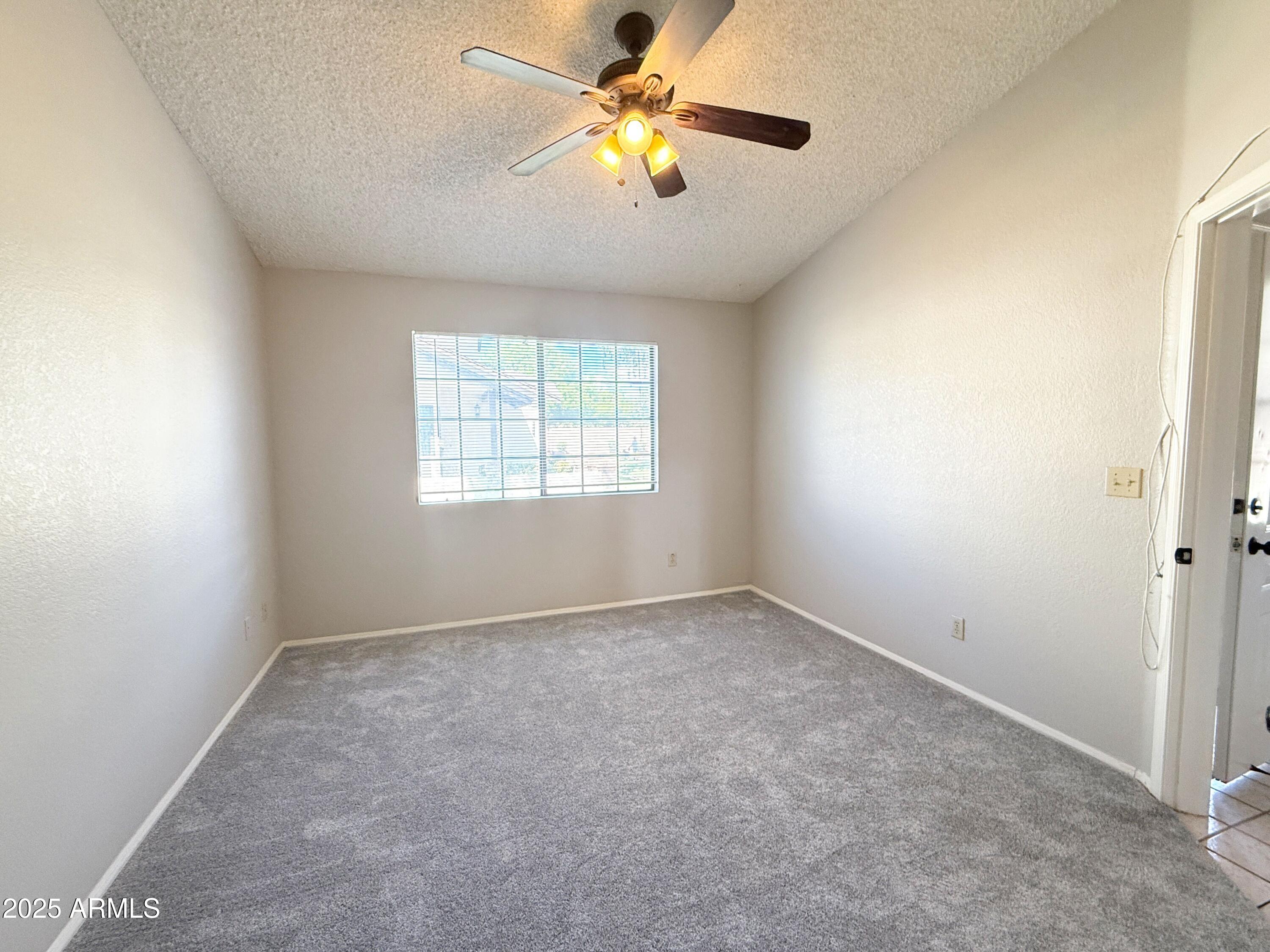 170 East Guadalupe Road, Unit 130 Gilbert, AZ 85234 - Photo 9 of 18 wooden floor in an empty room with a window
