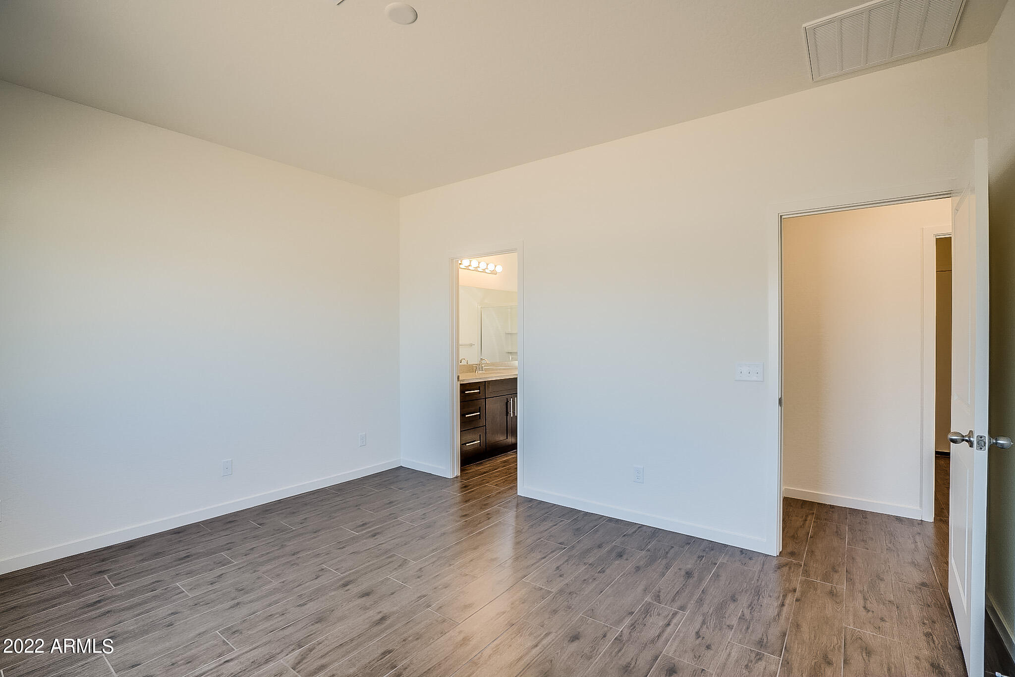 15 Reflection Canyon Drive Page, AZ 86040 - Photo 12 of 16 a view of an empty room with wooden floor and a window