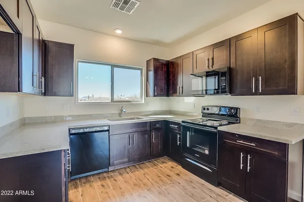 a view of a kitchen with a sink and a window