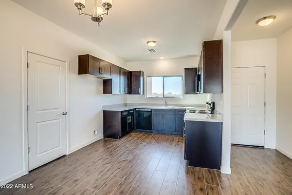 a kitchen with stainless steel appliances granite countertop a sink stove and cabinets