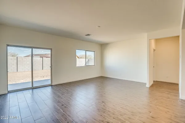 a kitchen with stainless steel appliances kitchen island granite countertop a refrigerator a sink dishwasher and a stove with wooden floor