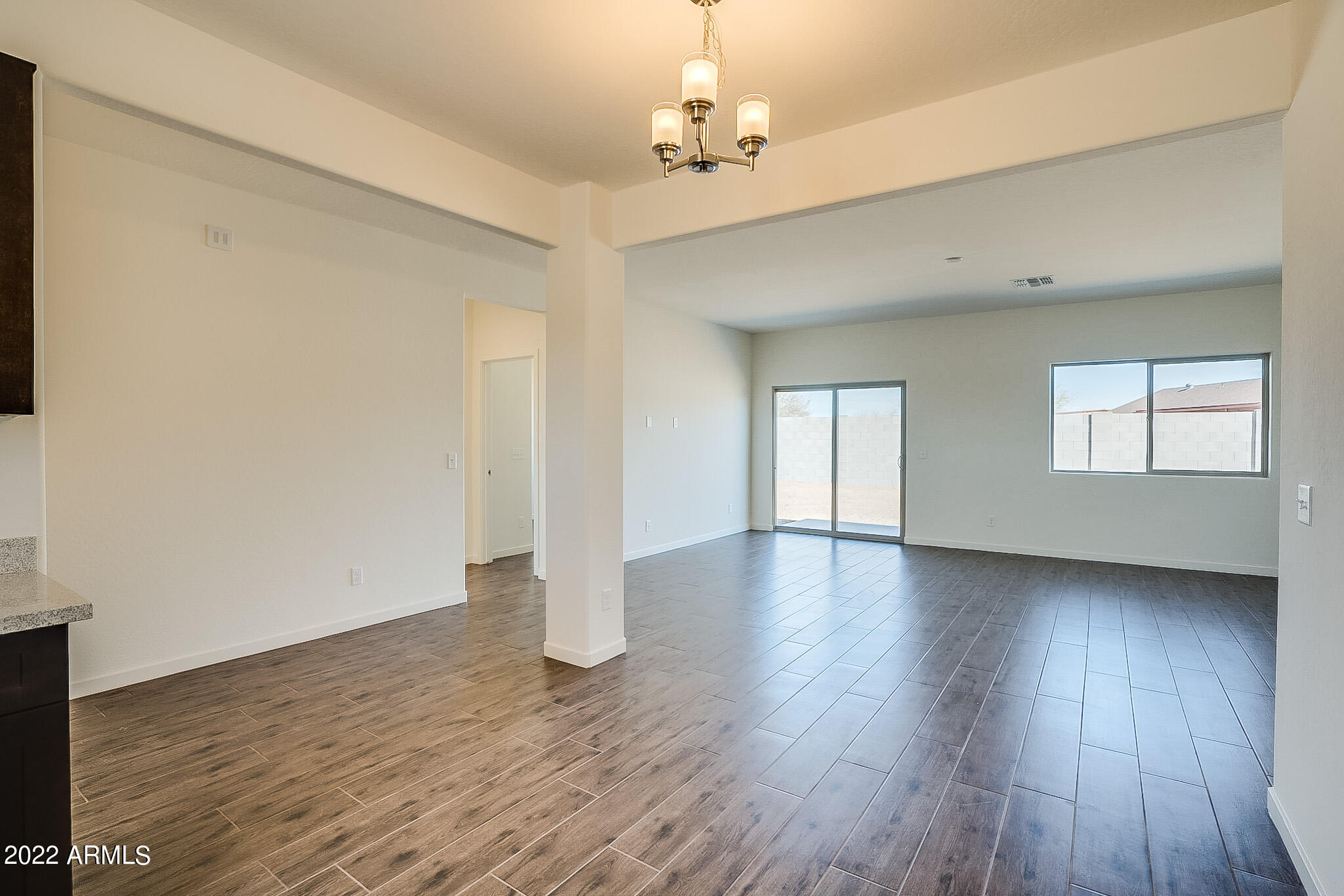 15 Reflection Canyon Drive Page, AZ 86040 - Photo 6 of 16 a view of an empty room with wooden floor and a window