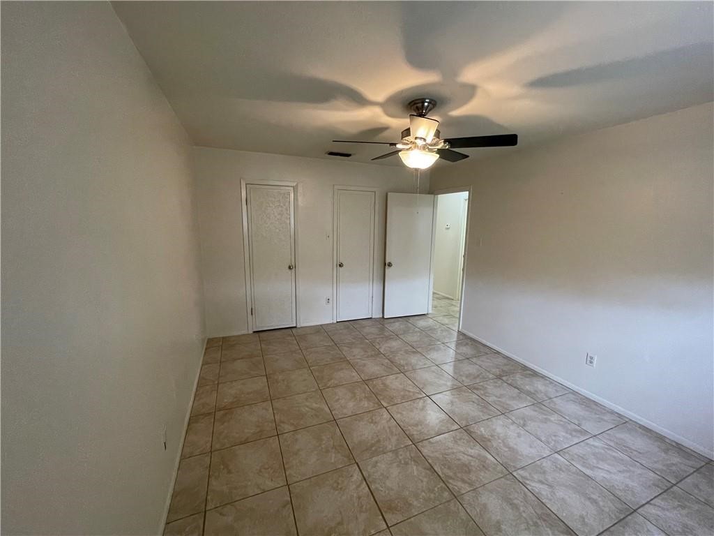 2123 Zephyr Circle Ingleside, TX 78362 - Photo 14 of 29 an empty room with a chandelier fan and windows