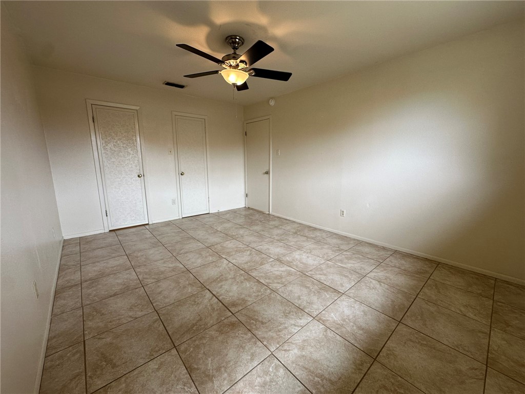 2123 Zephyr Circle Ingleside, TX 78362 - Photo 18 of 29 an empty room with a ceiling fan and window
