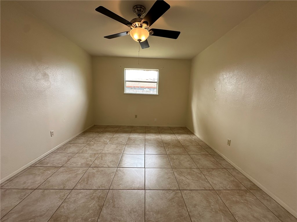 2123 Zephyr Circle Ingleside, TX 78362 - Photo 20 of 29 a view of an empty room and a ceiling fan and window