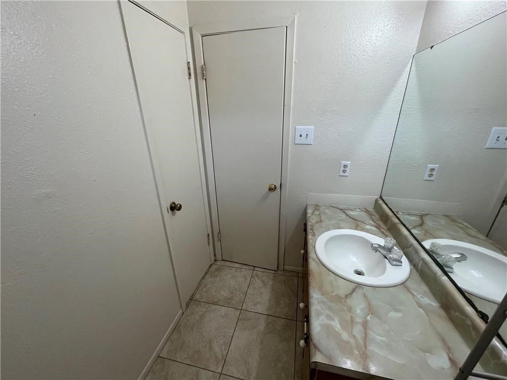 2123 Zephyr Circle Ingleside, TX 78362 - Photo 28 of 29 a bathroom with a granite countertop sink a mirror and a toilet