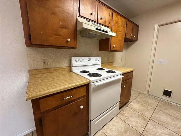 a kitchen with stainless steel appliances granite countertop a stove and a microwave