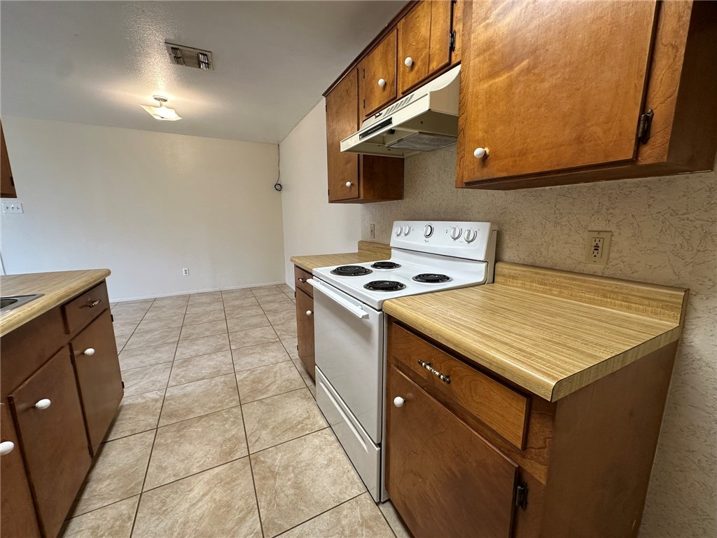 2123 Zephyr Circle Ingleside, TX 78362 - Photo 9 of 29 a kitchen with a sink a stove top oven and cabinetry