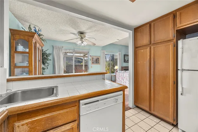 a view of a kitchen cabinets a sink and a refrigerator