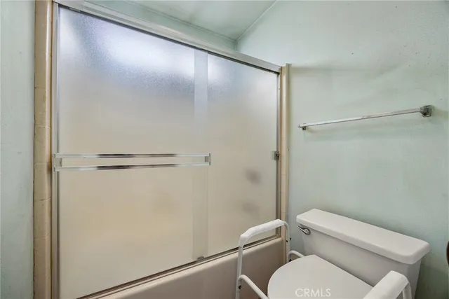 a white toilet sitting next to a bathroom sink