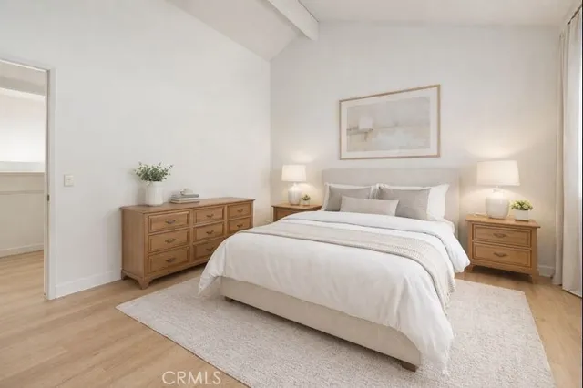 a bedroom with a bed and lamp with window