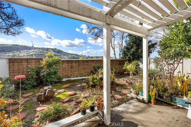 a view of a porch with a floor to ceiling window next to a yard