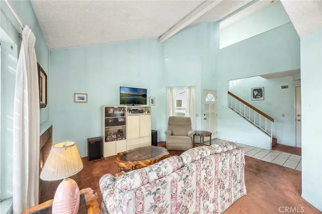 a bedroom with furniture and a flat screen tv