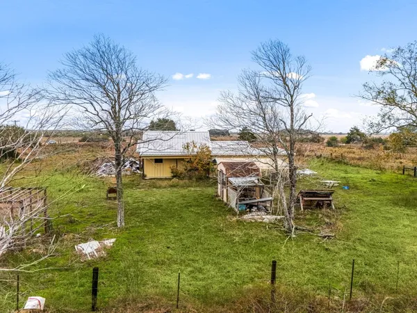 a aerial view of a house with garden space and ocean view