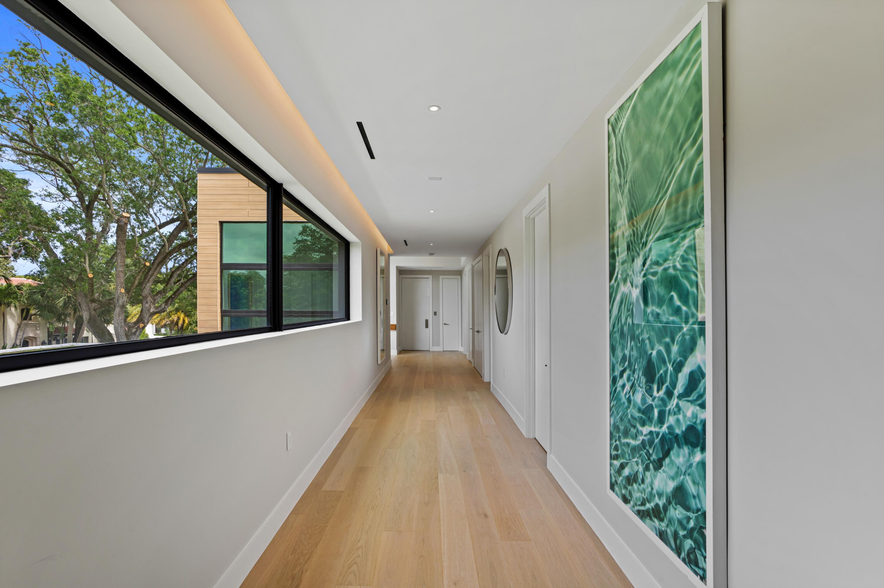 754 Oleander Street Boca Raton, FL 33486 - Photo 23 of 41 a view of hallway with a large window and wooden floor