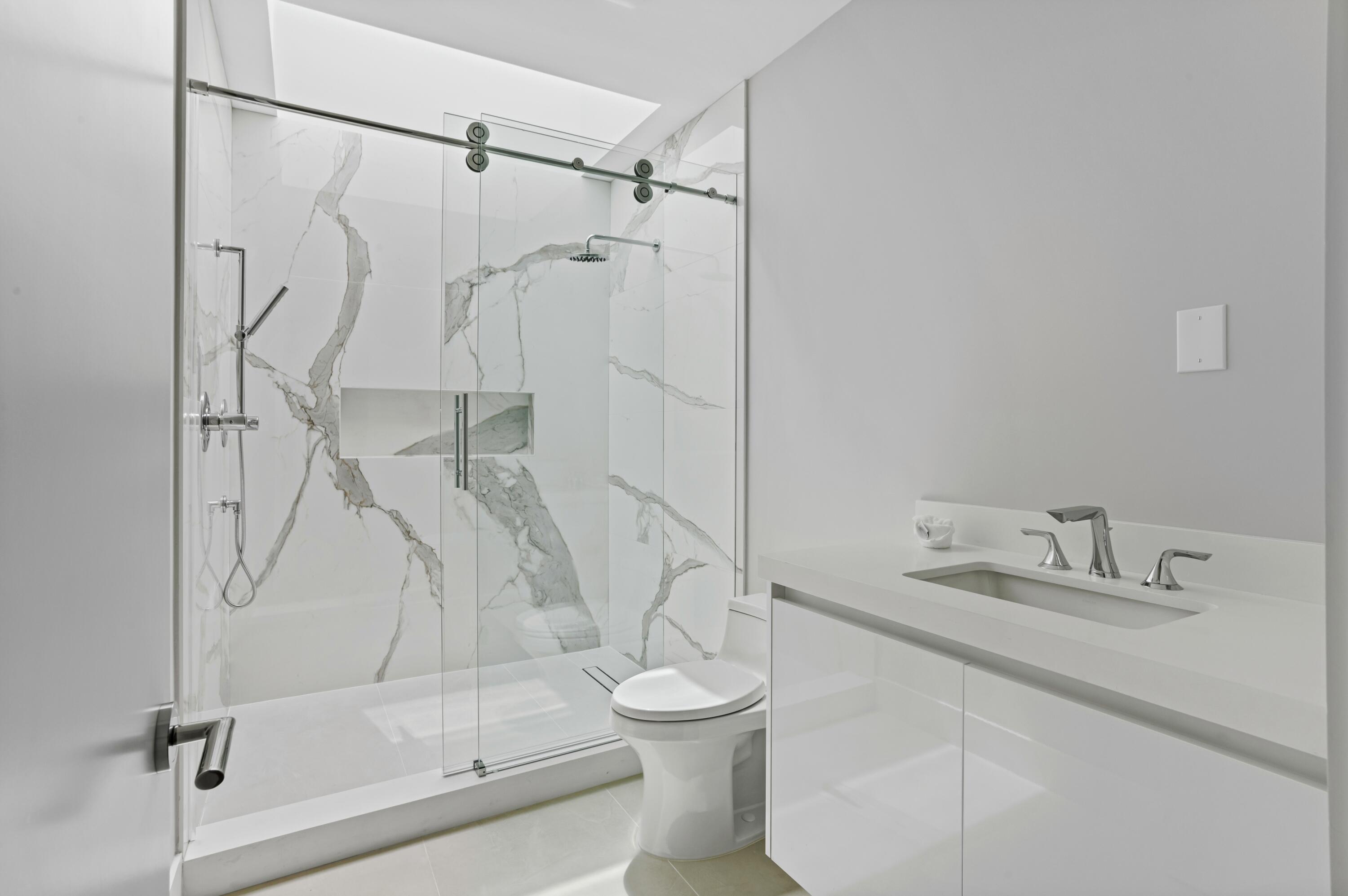 754 Oleander Street Boca Raton, FL 33486 - Photo 26 of 41 a bathroom with a shower and a toilet