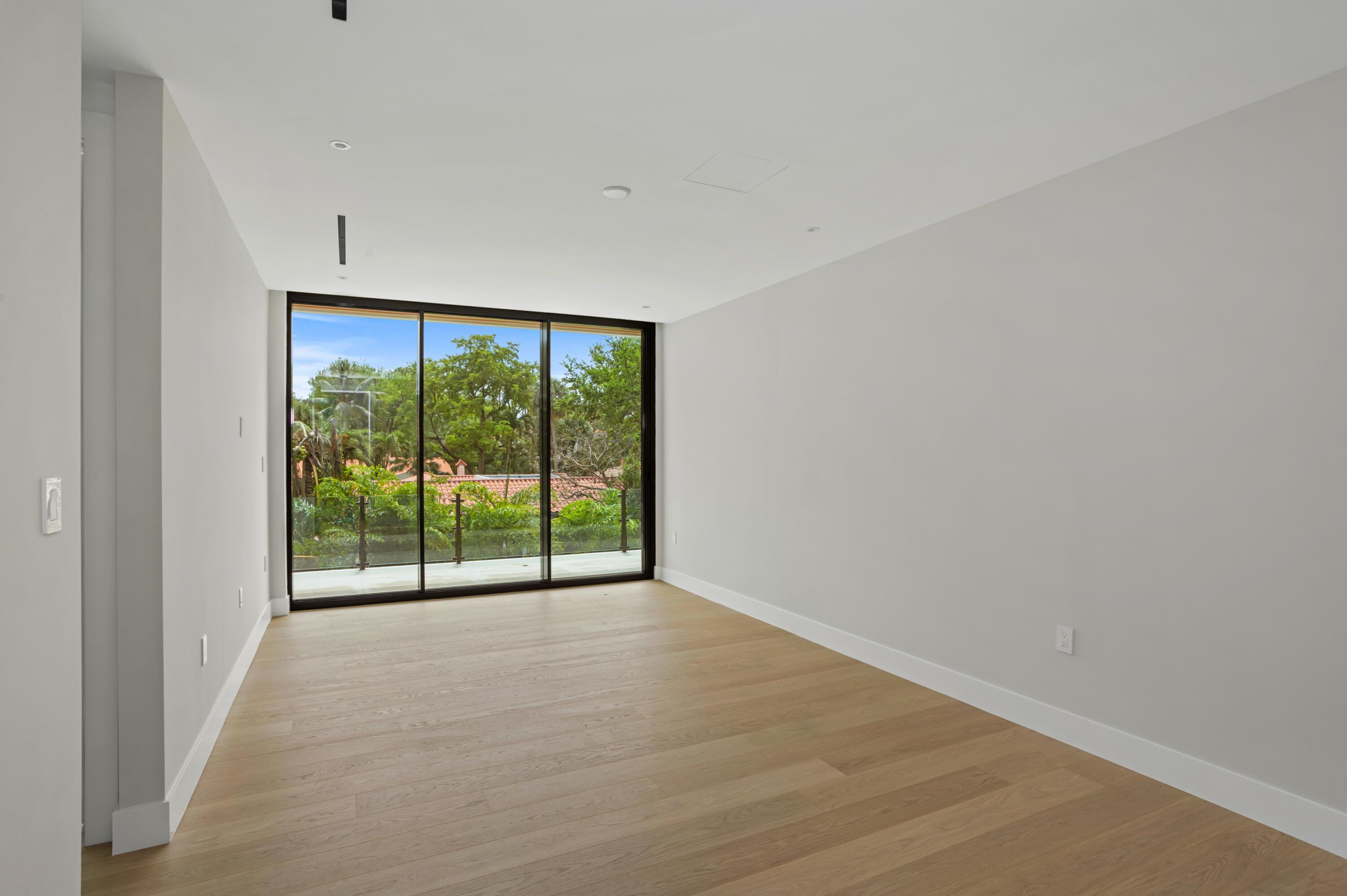 754 Oleander Street Boca Raton, FL 33486 - Photo 27 of 41 a view of an empty room with wooden floor and a window