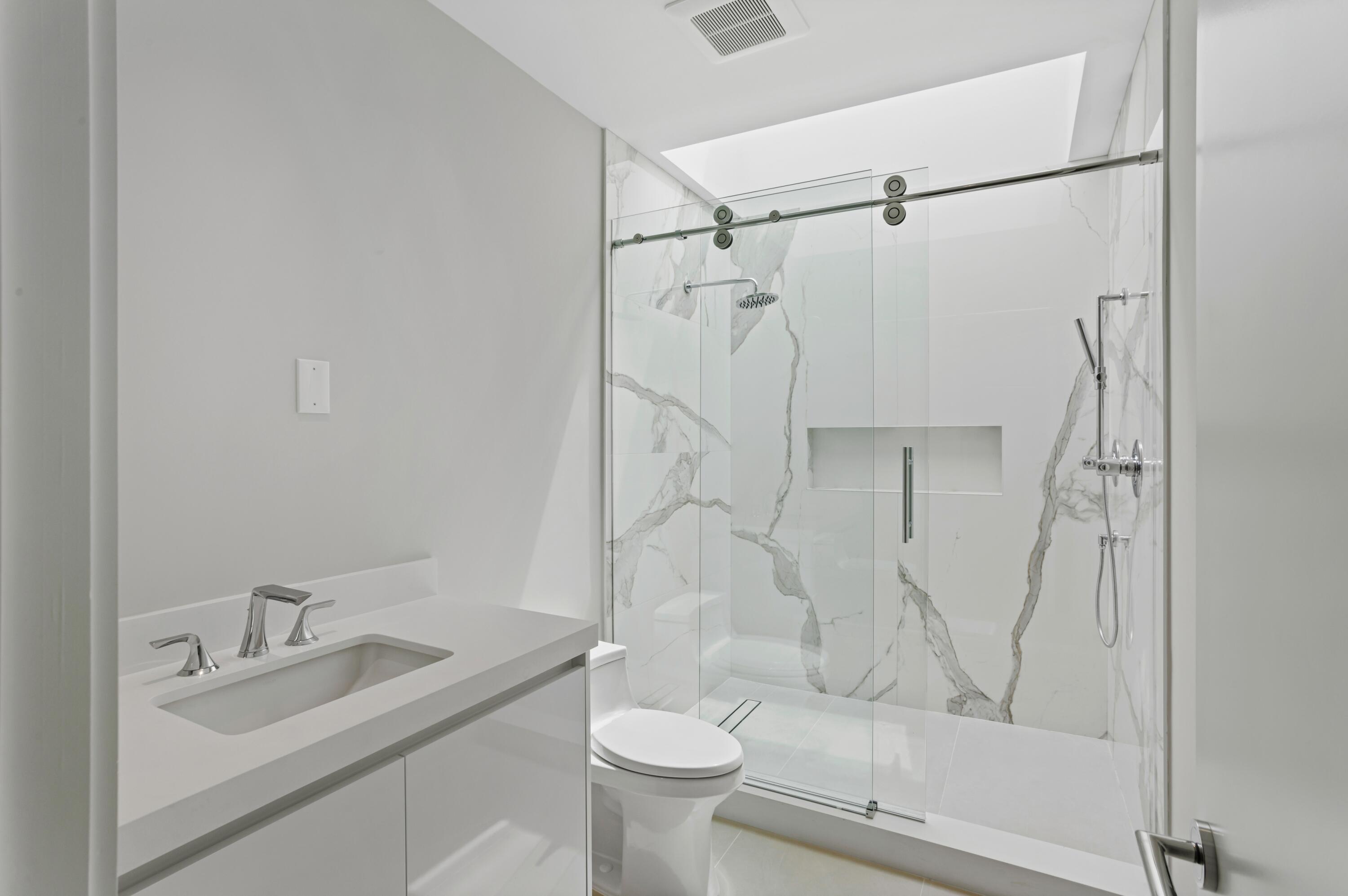 754 Oleander Street Boca Raton, FL 33486 - Photo 28 of 41 a bathroom with a granite countertop sink toilet and shower