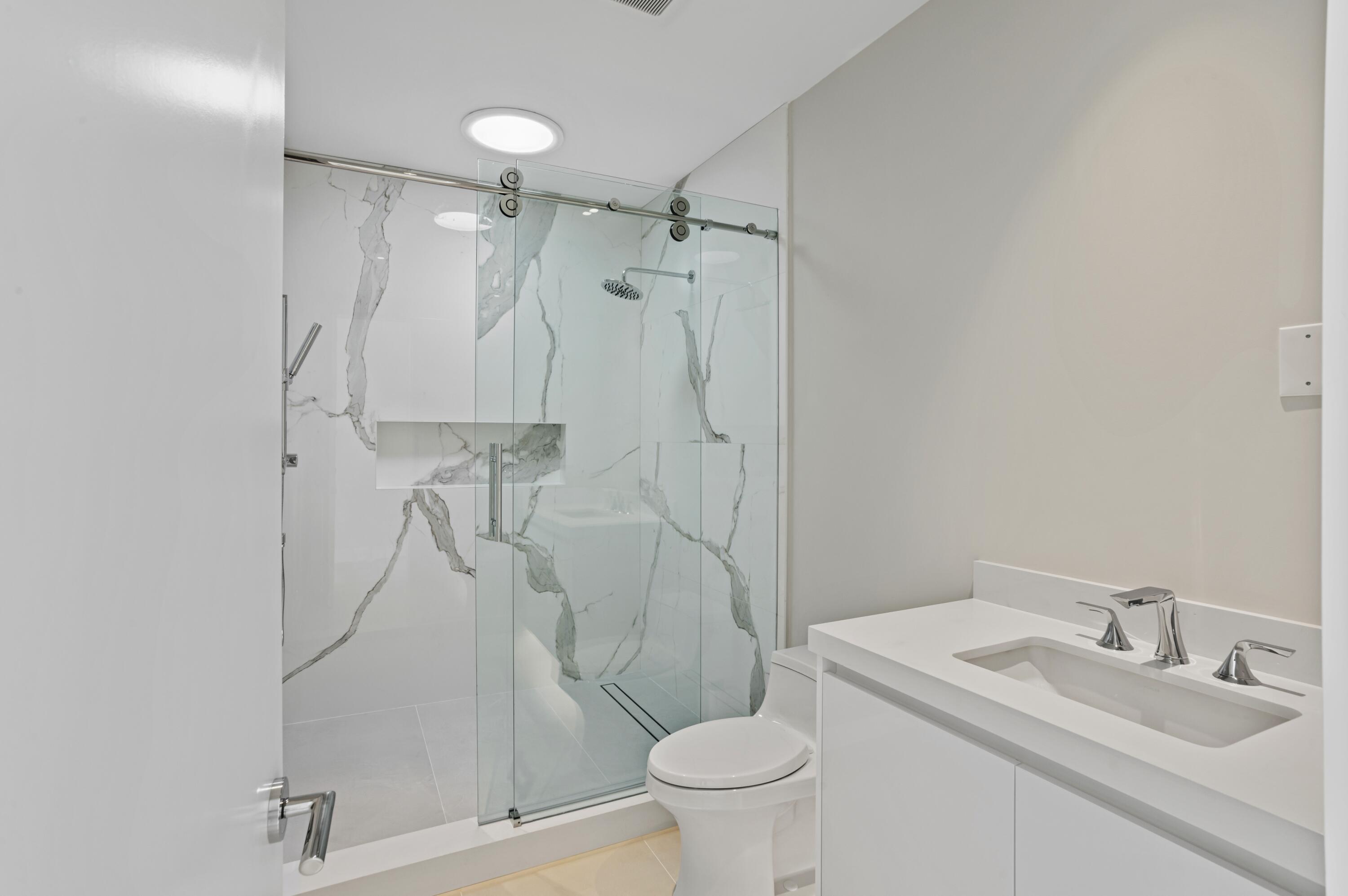 754 Oleander Street Boca Raton, FL 33486 - Photo 30 of 41 a bathroom with a granite countertop sink toilet and shower