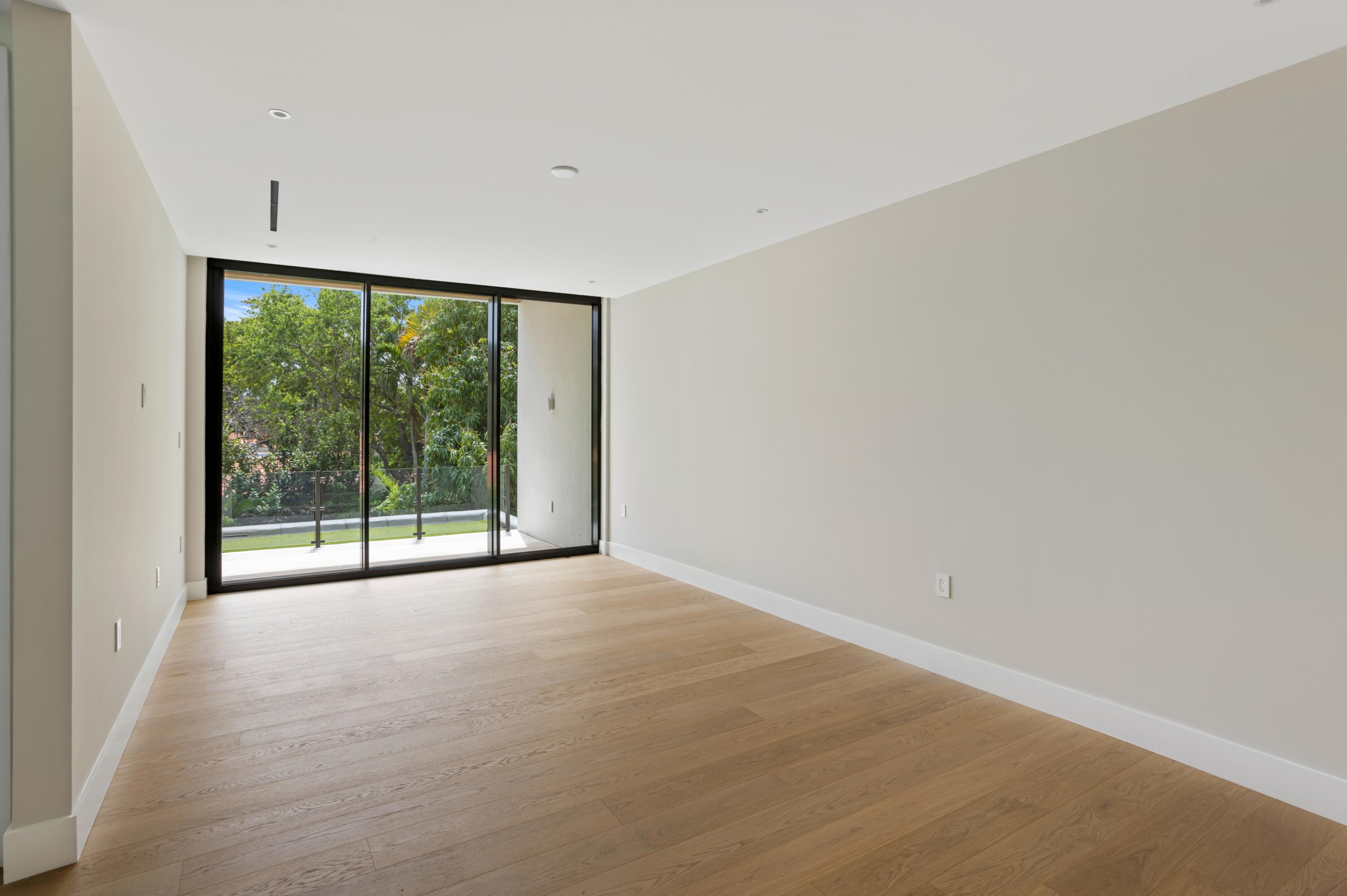 754 Oleander Street Boca Raton, FL 33486 - Photo 31 of 41 a view of an empty room with wooden floor and a window