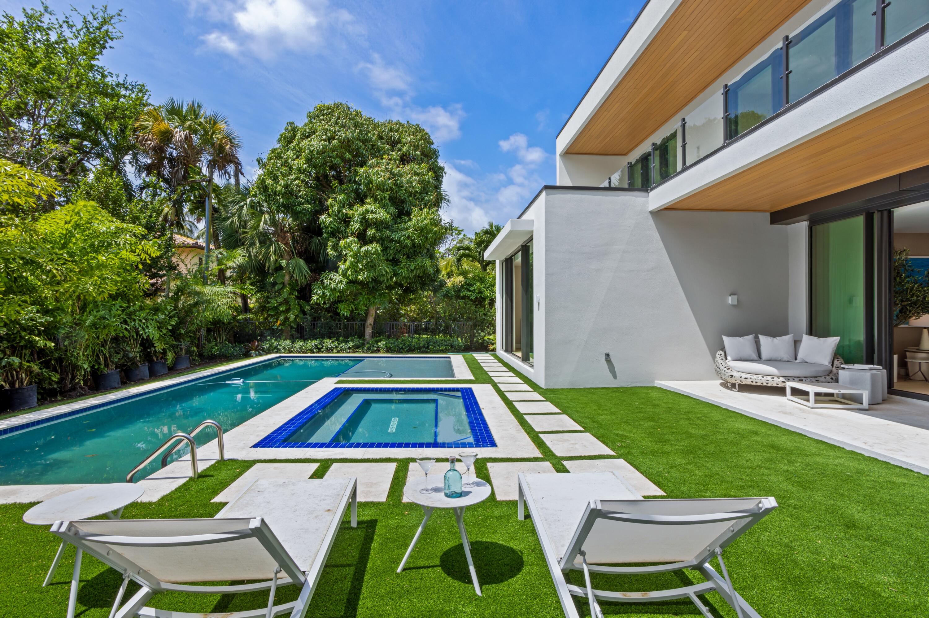 754 Oleander Street Boca Raton, FL 33486 - Photo 36 of 41 a backyard of a house with table and chairs
