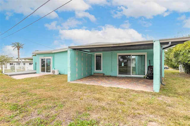 a view of a house with backyard and porch