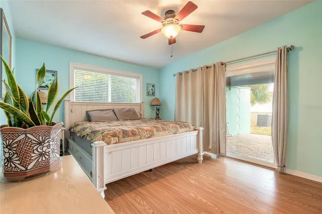 a bedroom with a large bed and a chandelier